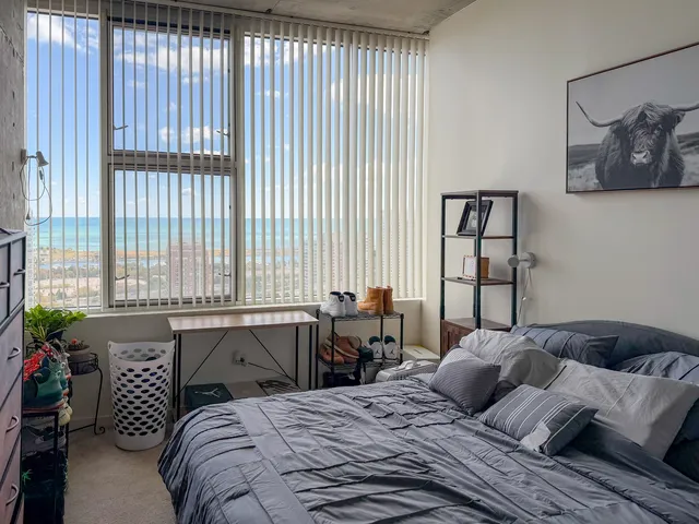 a bedroom with a bed and a window