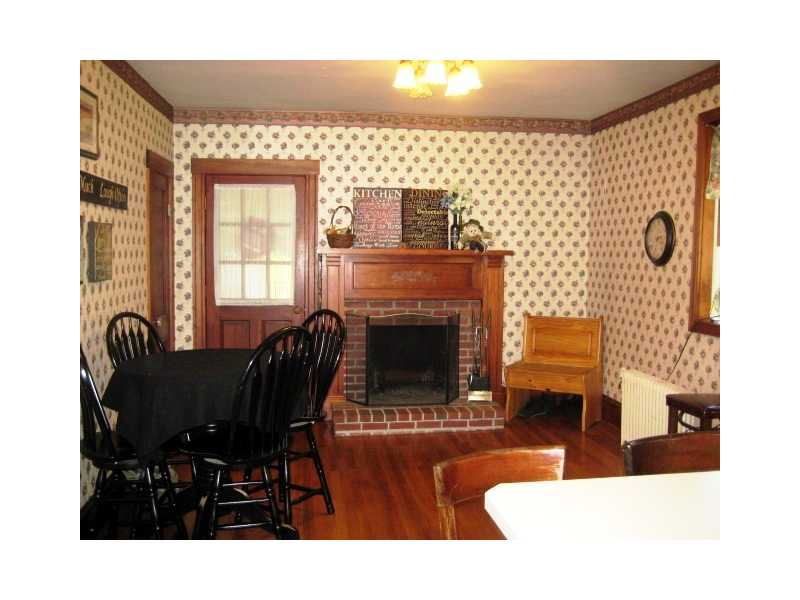 95 Huntington Avenue Woonsocket, RI 02895 - Photo 4 of 25 Kitchen. Breakfast Room with Fireplace and Hardwoods - Opens to Spacious Kitchen and Seasonal Sun Room