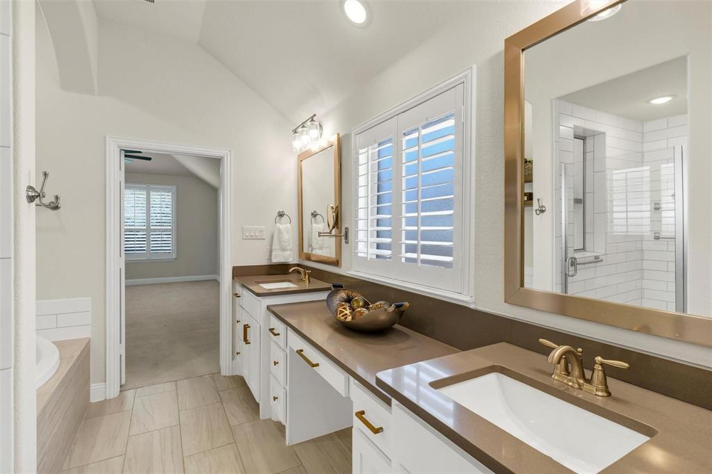 1928 Crested Ridge Road Fort Worth, TX 76008 - Photo 13 of 29 a bathroom with double vanity sinks a granite tub shower and a mirror