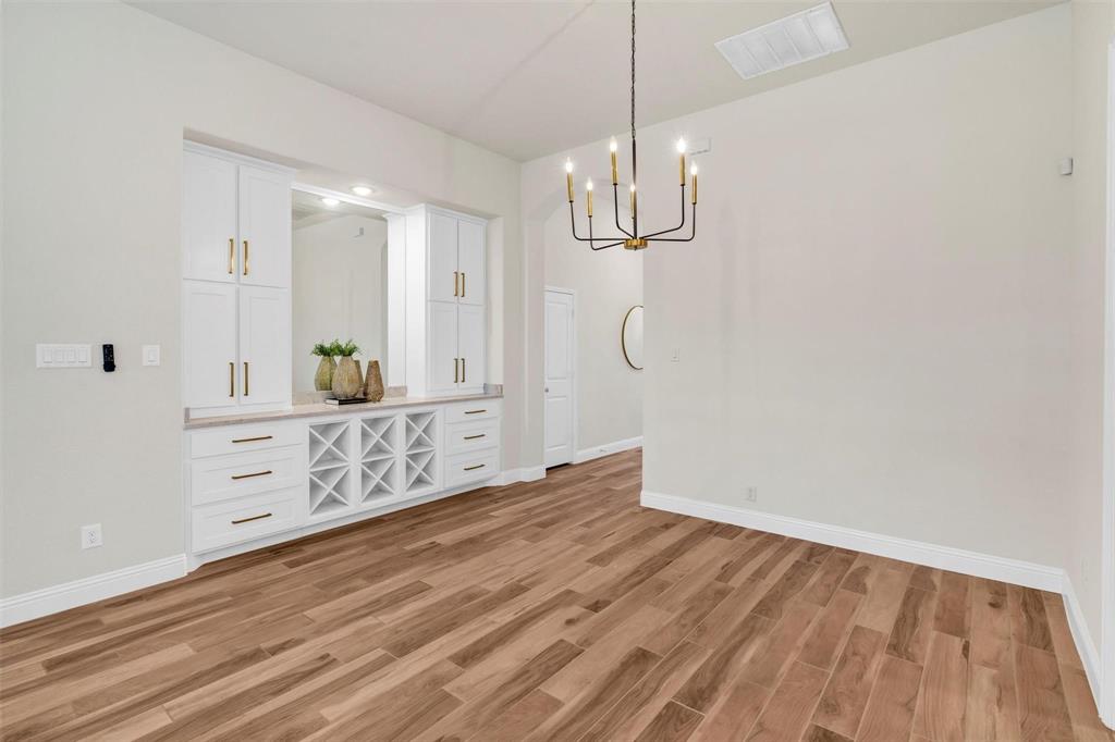 1928 Crested Ridge Road Fort Worth, TX 76008 - Photo 14 of 29 a view of a room with cabinet wooden floor and chandelier