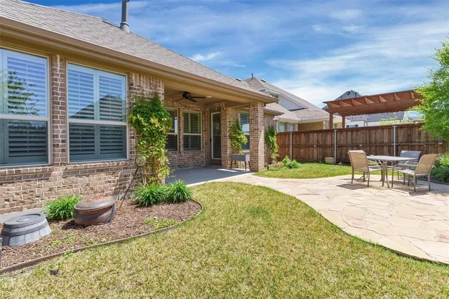 a view of a chair and tables in the patio