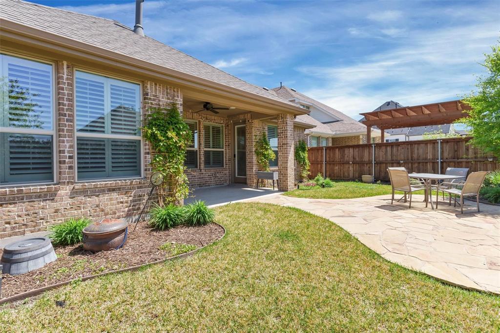 1928 Crested Ridge Road Fort Worth, TX 76008 - Photo 22 of 29 a view of a chair and tables in the patio