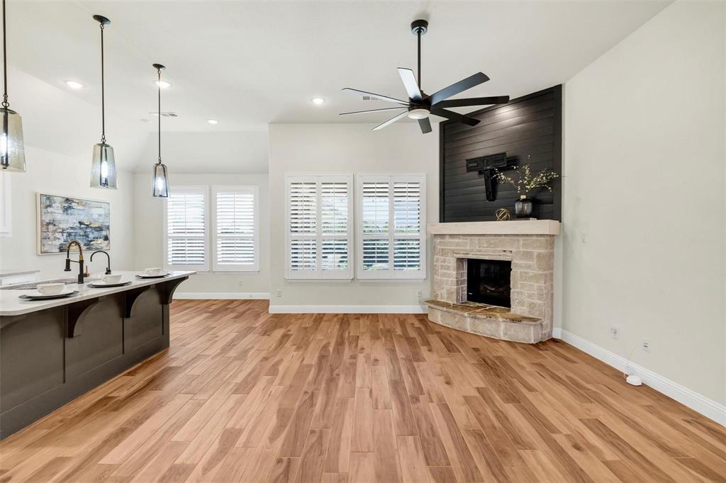 1928 Crested Ridge Road Fort Worth, TX 76008 - Photo 4 of 29 a view of empty room with wooden floor and fan