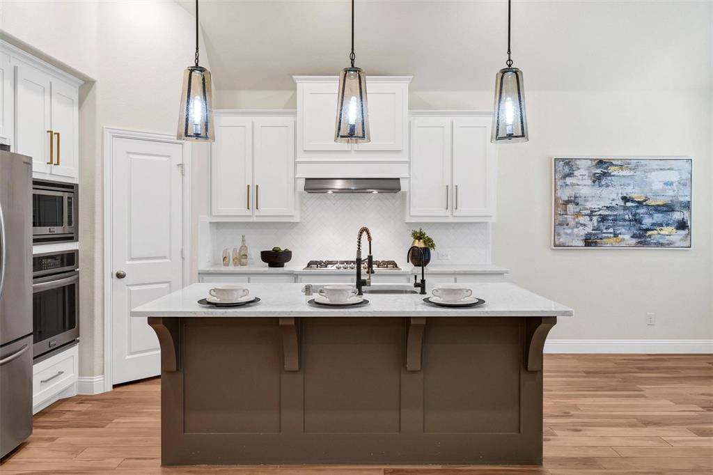 1928 Crested Ridge Road Fort Worth, TX 76008 - Photo 8 of 29 a kitchen with stainless steel appliances granite countertop a sink a stove and refrigerator