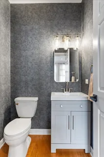 a bathroom with a toilet a sink and mirror