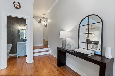 a kitchen with kitchen island a sink appliances and a wooden floor