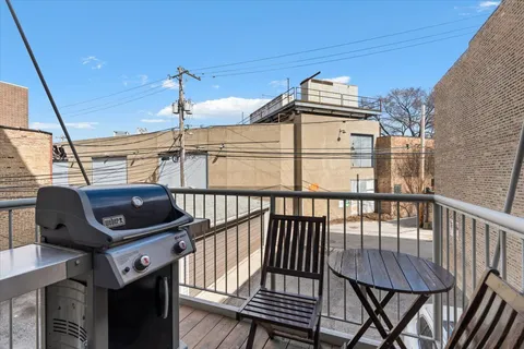 a view of a balcony with a table and chairs