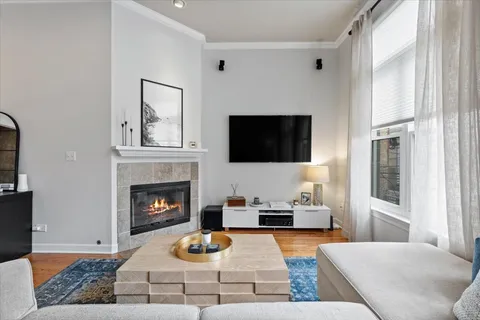 a living room with furniture fireplace and flat screen tv