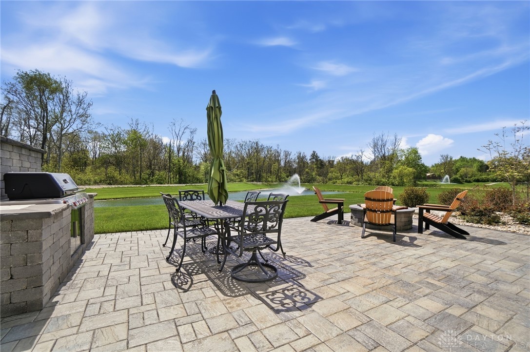 1247 Normandy Rue Dayton, OH 45458 - Photo 61 of 76 This expansive patio features a built-in gas barbecue and fire pit, perfect for outdoor entertaining by the water.