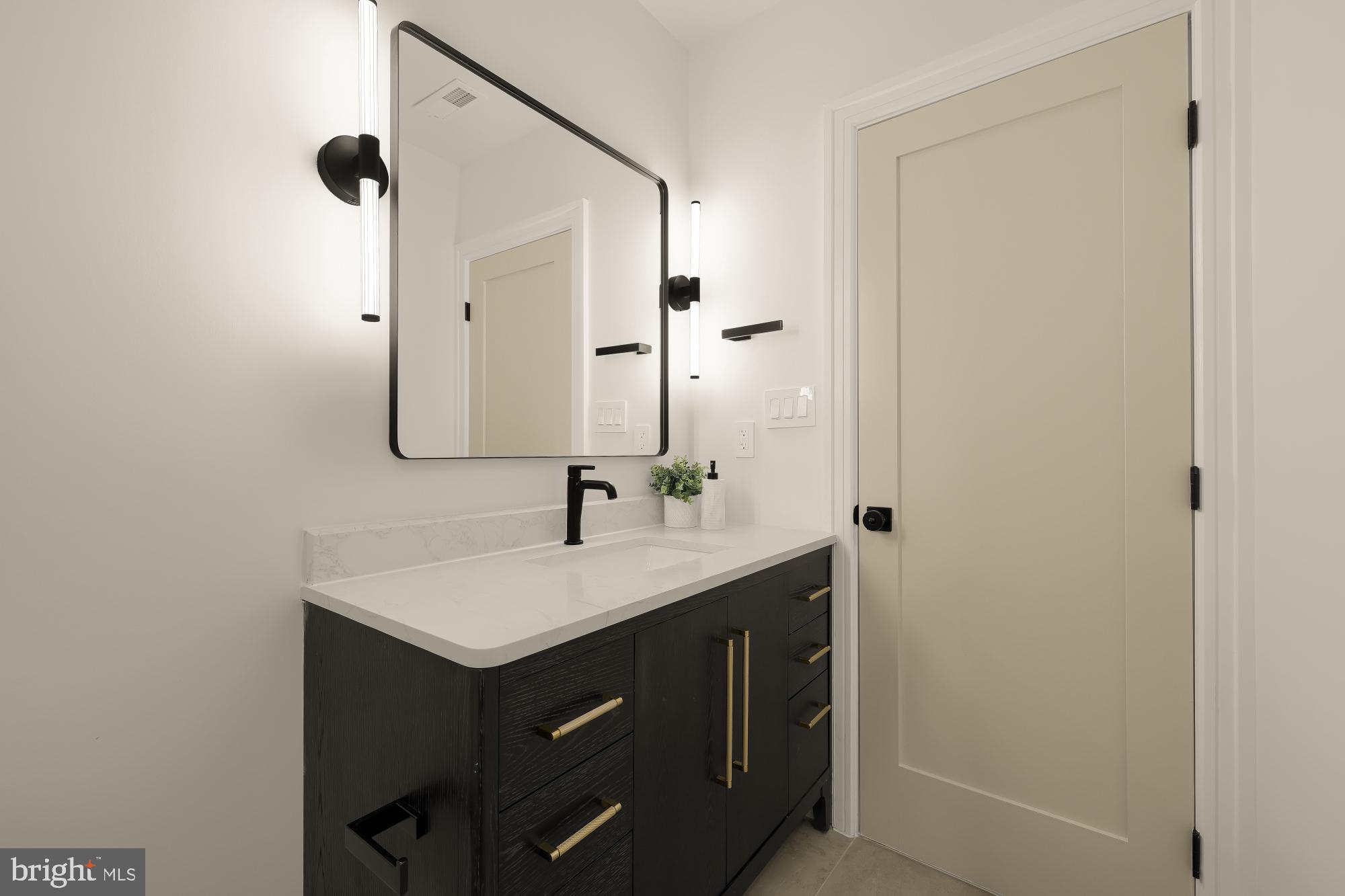 1463 Harvard Street Northwest, Unit 2 Washington, DC 20009 - Photo 18 of 25 a bathroom with a sink and a mirror