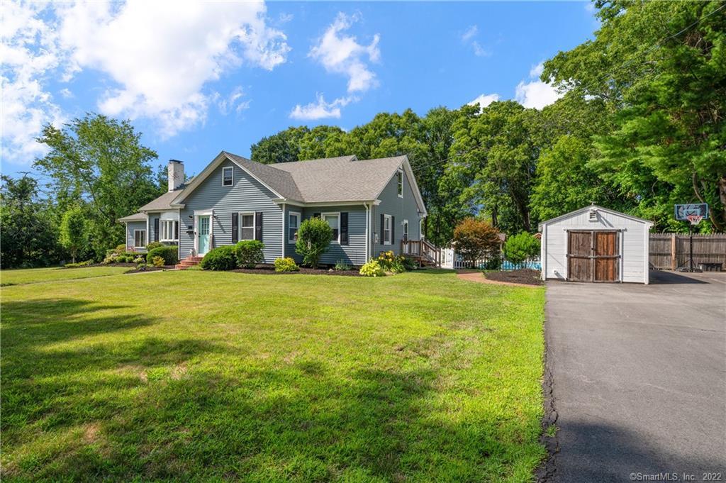 a front view of a house with yard and green space