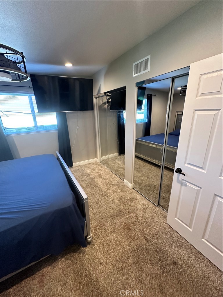 18470 7th Street Bloomington, CA 92316 - Photo 18 of 45 a bed room with a bed and a television