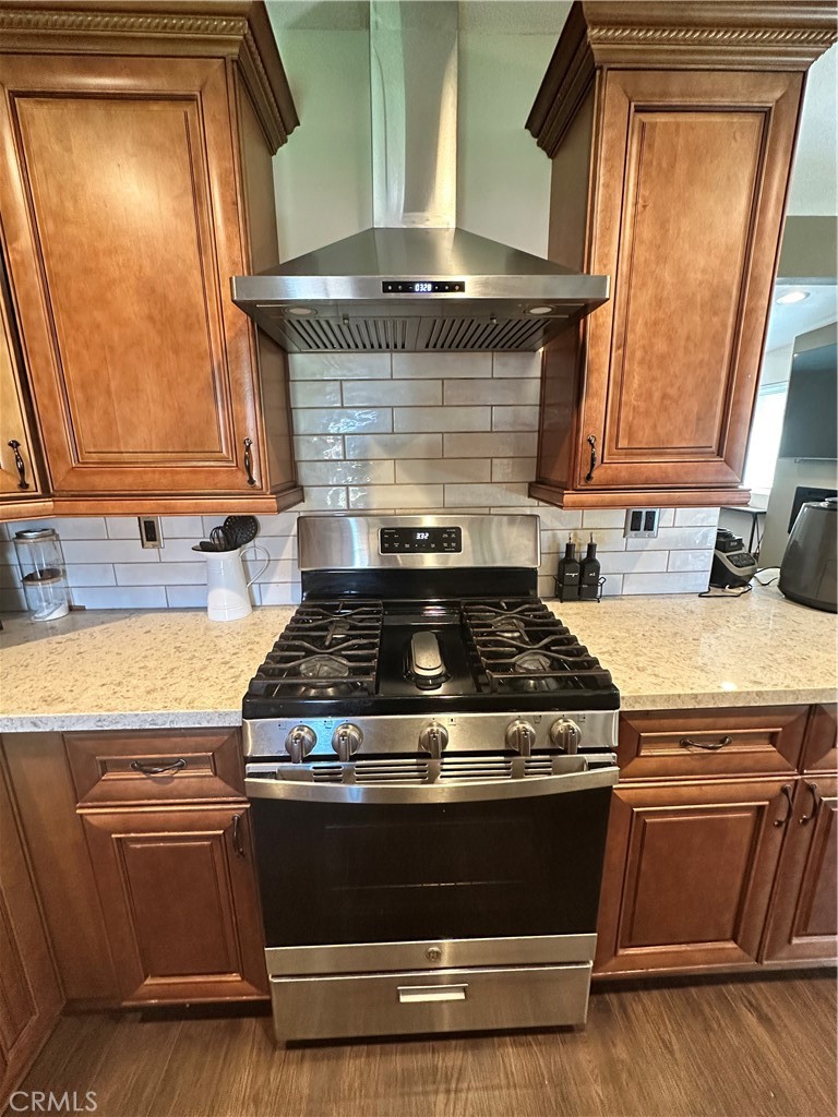 18470 7th Street Bloomington, CA 92316 - Photo 21 of 45 a stove top oven sitting inside of a kitchen