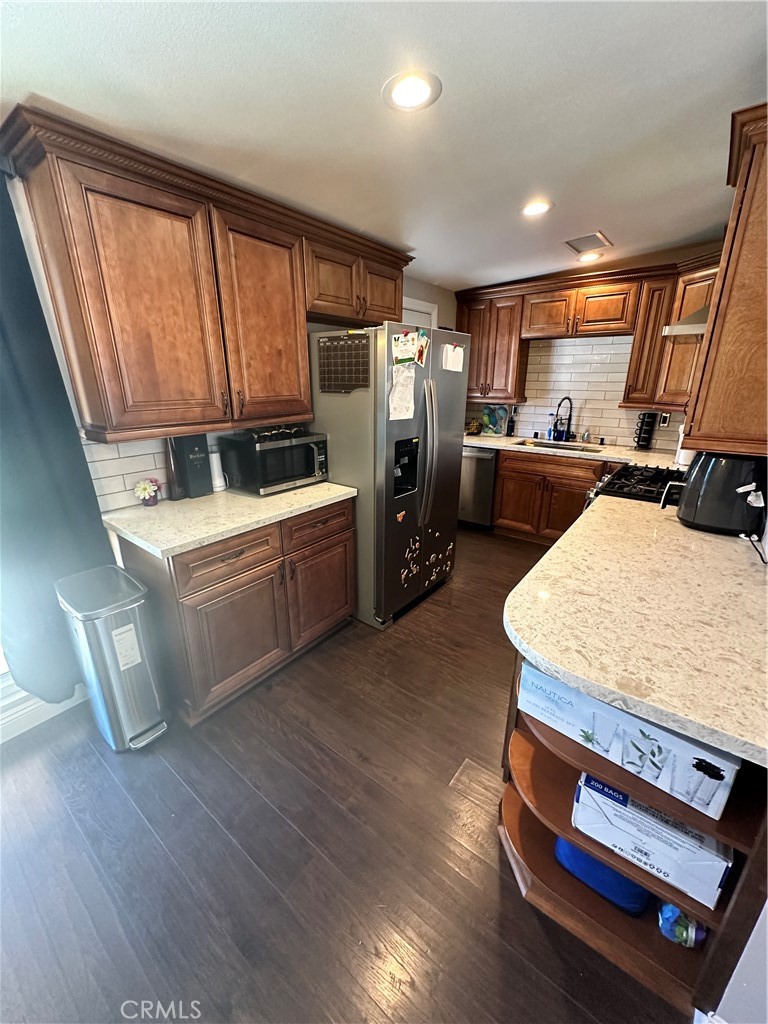 18470 7th Street Bloomington, CA 92316 - Photo 25 of 45 a kitchen with sink a refrigerator and wooden floor