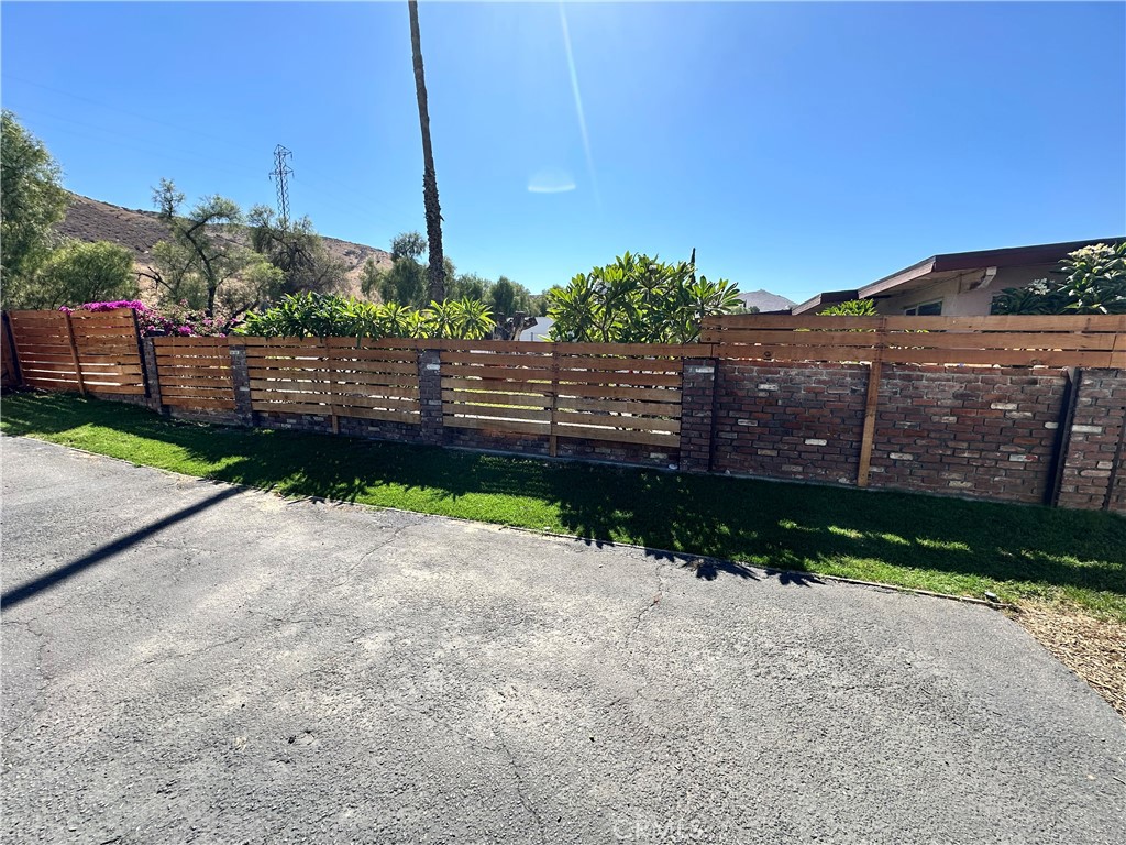 18470 7th Street Bloomington, CA 92316 - Photo 44 of 45 a view of a street with a wooden fence