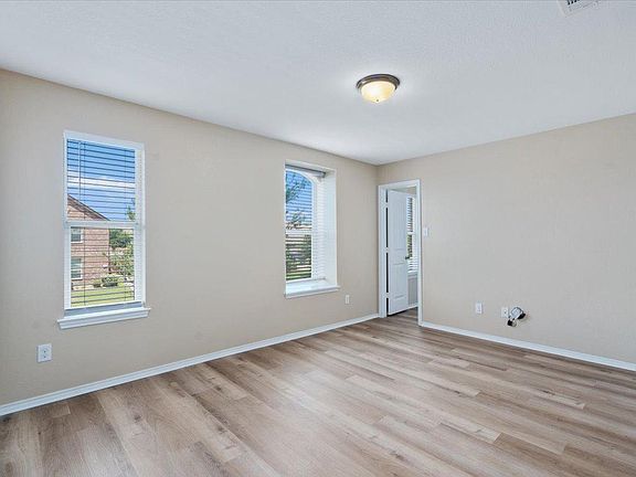 904 Lonesome Lilly Way Pflugerville, TX 78660 - Photo 28 of 34 This bright room features light-colored walls and wood-look flooring, creating a neutral palette