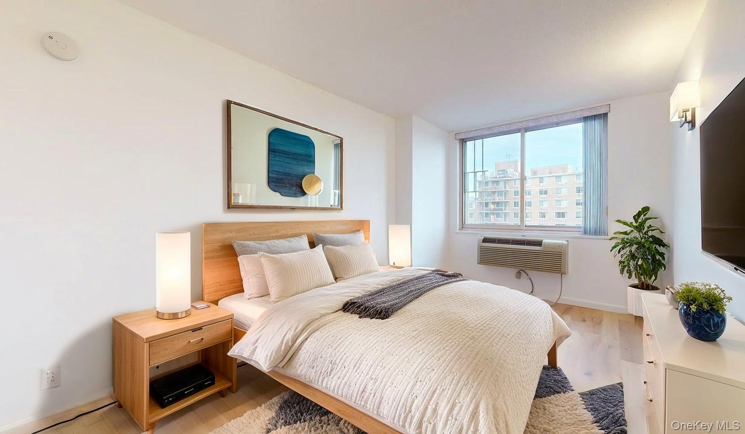 118-17 Union Turnpike, Unit 18H Queens, NY 11375 - Photo 23 of 49 Bedroom featuring light wood-style flooring and a wall mounted AC