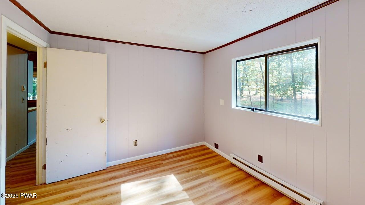 105 Roundhill Road Dingmans Ferry, PA 18328 - Photo 8 of 18 a view of a room with wooden floor and windows