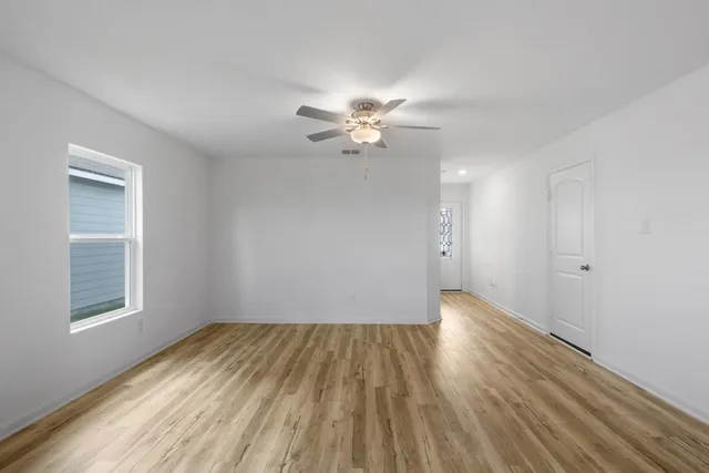 wooden floor in an empty room with a window