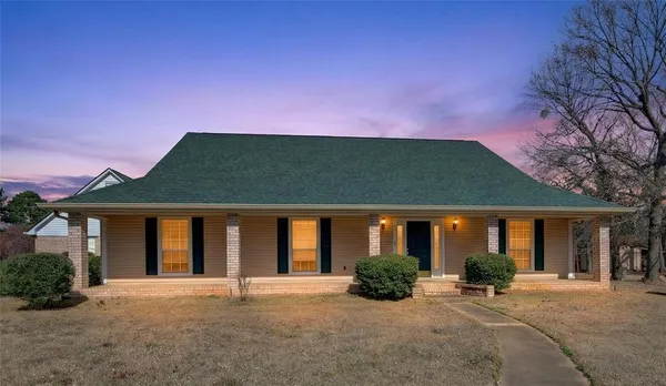 a front view of a house with a garden and porch