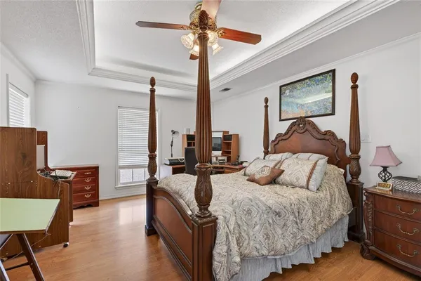 a bedroom with bed and a chandelier