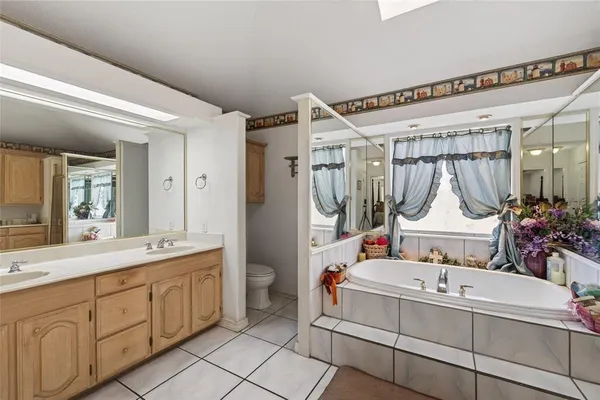 a bathroom with a sink a mirror and a shower