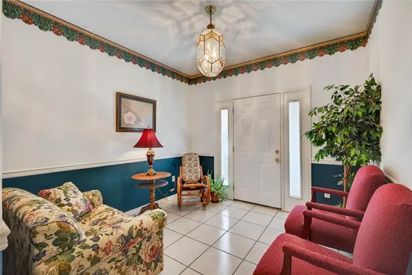 a living room with furniture and a chandelier