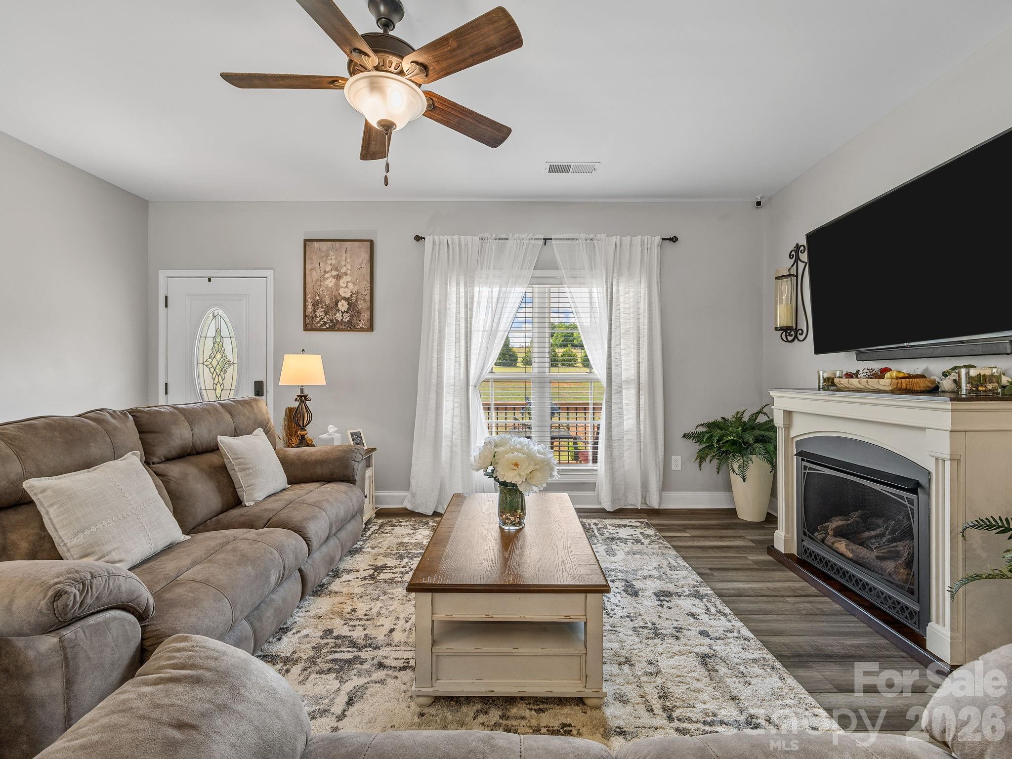 1076 McSwain Road Chesnee, SC 29323 - Photo 6 of 36 a living room with furniture a flat screen tv and a fireplace