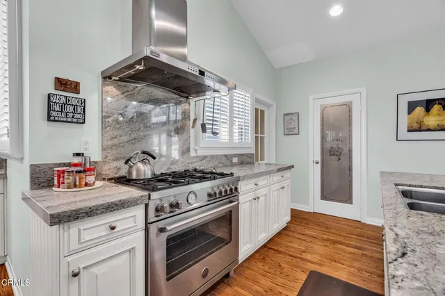 a kitchen with stainless steel appliances granite countertop a sink and cabinets
