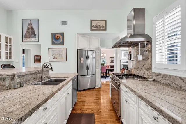 a bedroom with a bed lamps and a large mirror on the dresser