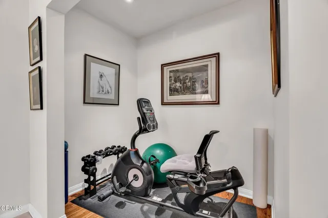 a bedroom with a bed a mirror on dresser and a chandelier