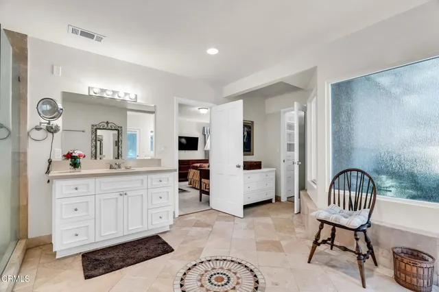 a view of a bedroom with cabinet and window