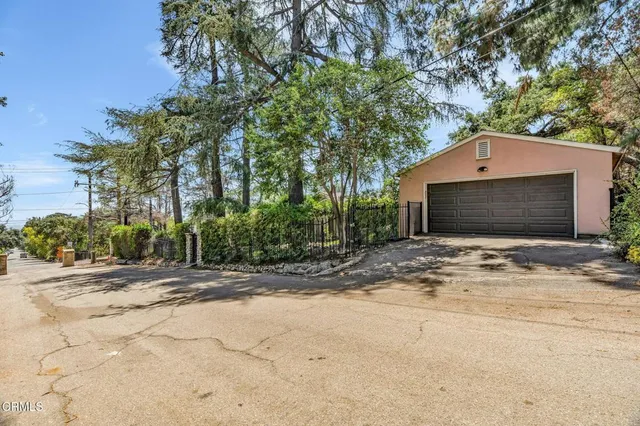 a front view of a house with a yard and potted plants