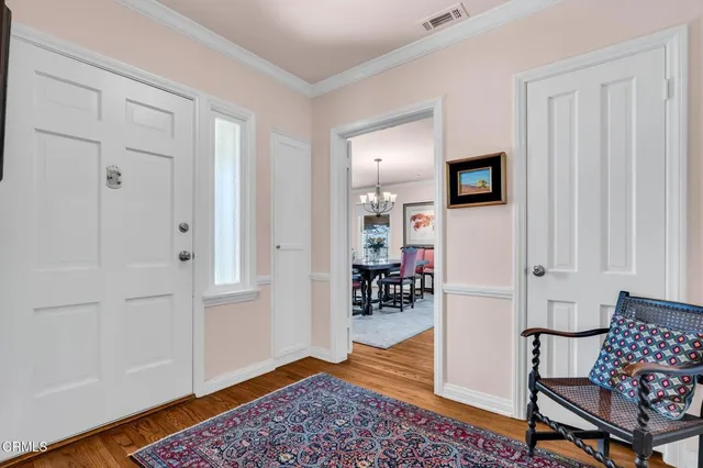 a living room with furniture a rug and a large window