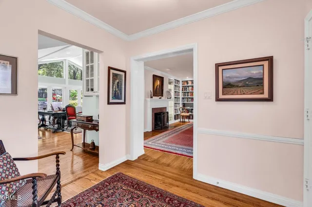 a living room with furniture a rug and a large window
