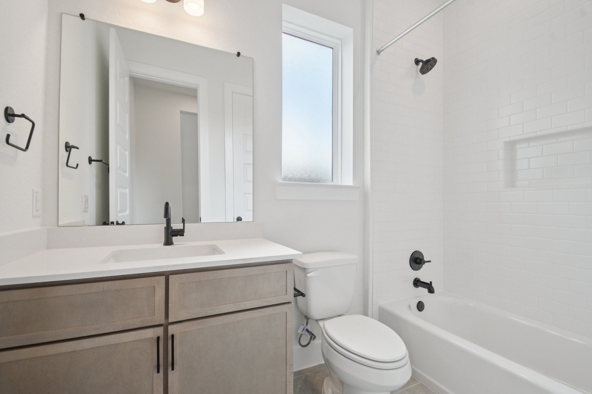 1660 Cardinal Lane Round Rock, TX 78681 - Photo 13 of 35 a bathroom with a sink toilet vanity and tub