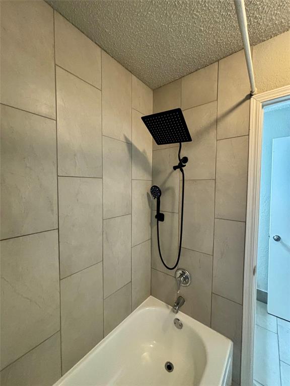 11655 Audelia Road, Unit 1304 Dallas, TX 75243 - Photo 10 of 11 Full bath with a textured ceiling and shower / washtub combination