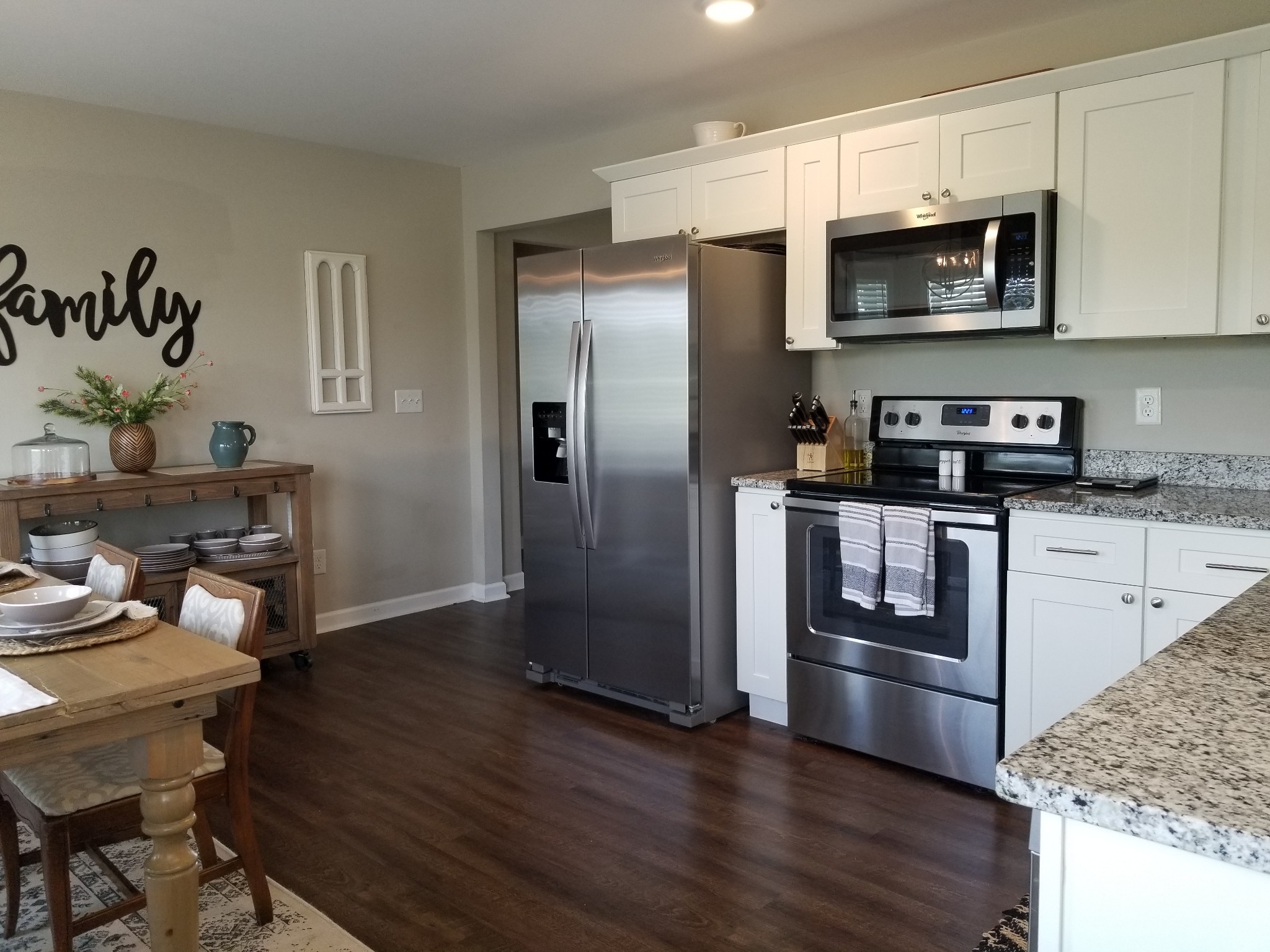 145 A T G T Road Portland, TN 37148 - Photo 15 of 41 a kitchen with granite countertop a refrigerator stove and microwave