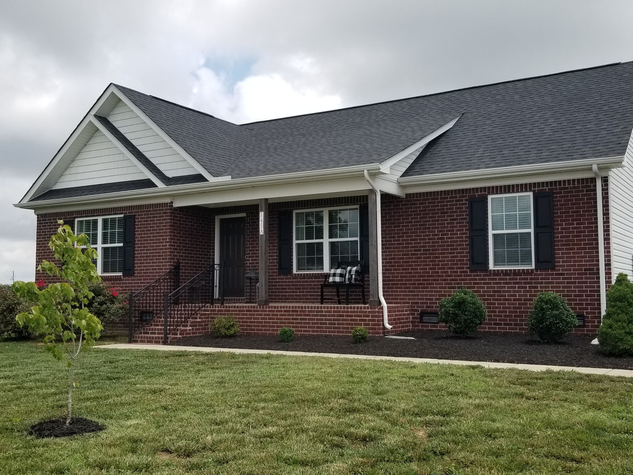 145 A T G T Road Portland, TN 37148 - Photo 3 of 41 a front view of a house with a yard and outdoor seating