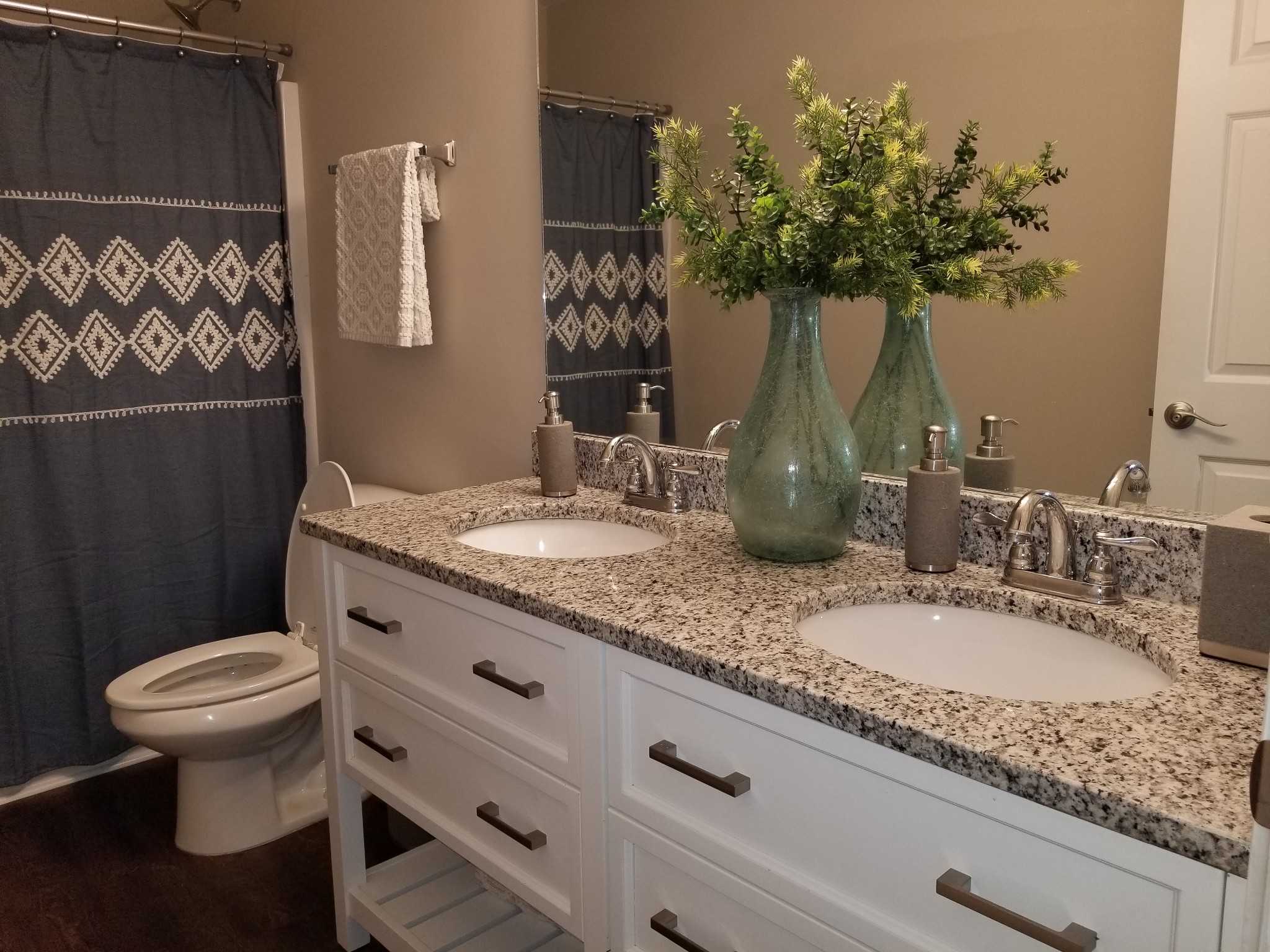 145 A T G T Road Portland, TN 37148 - Photo 29 of 41 a bathroom with a granite countertop sink a toilet and a mirror