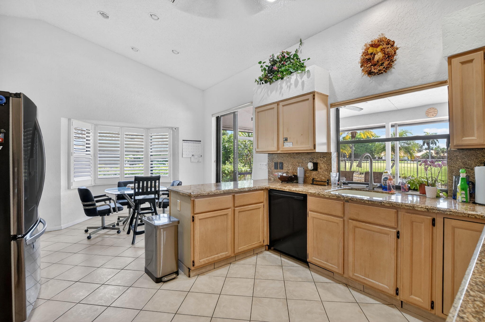 10226 Fresh Meadow Lane Boca Raton, FL 33498 - Photo 12 of 58 a kitchen with a sink window and cabinets