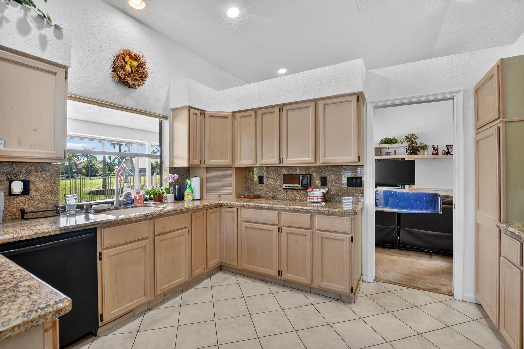 10226 Fresh Meadow Lane Boca Raton, FL 33498 - Photo 13 of 58 a kitchen with a sink cabinets and window