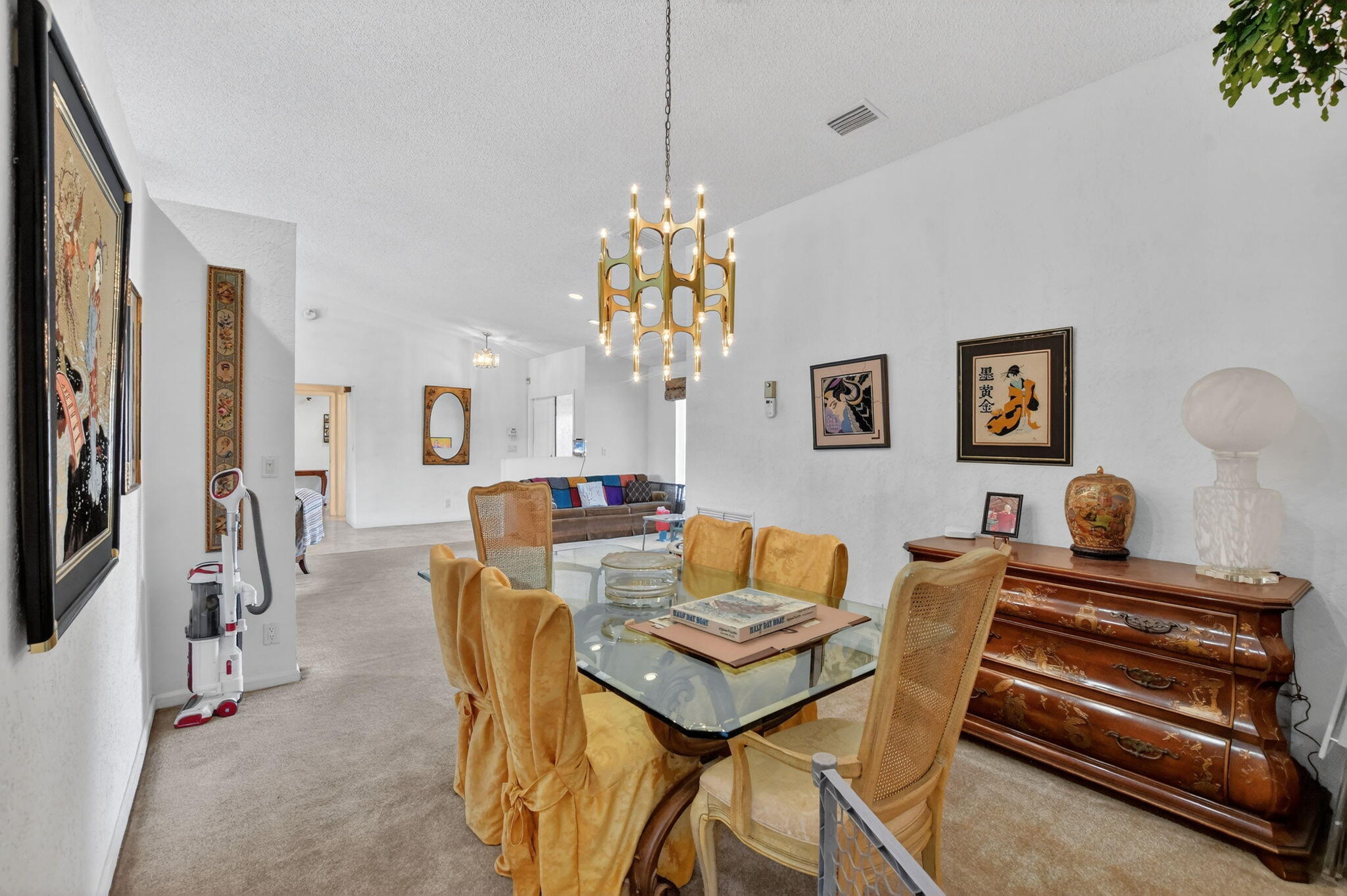 10226 Fresh Meadow Lane Boca Raton, FL 33498 - Photo 16 of 58 a dining room with furniture and a chandelier