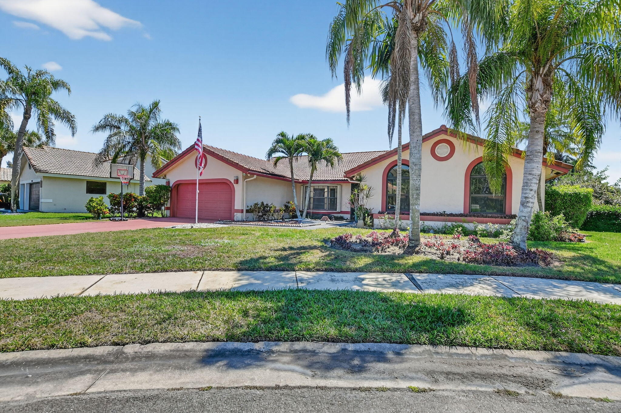 10226 Fresh Meadow Lane Boca Raton, FL 33498 - Photo 2 of 58 a front view of house with yard and green space