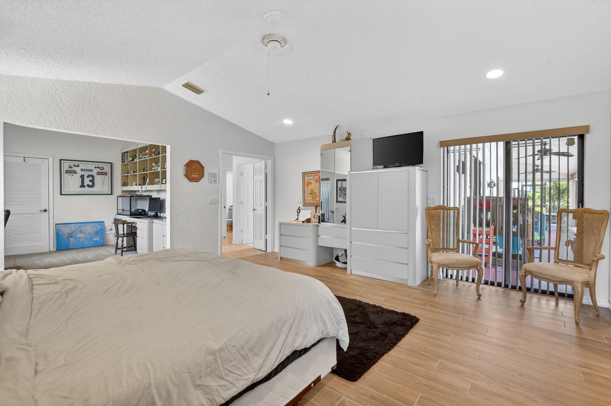 10226 Fresh Meadow Lane Boca Raton, FL 33498 - Photo 24 of 58 a spacious bedroom with a bed and a large window