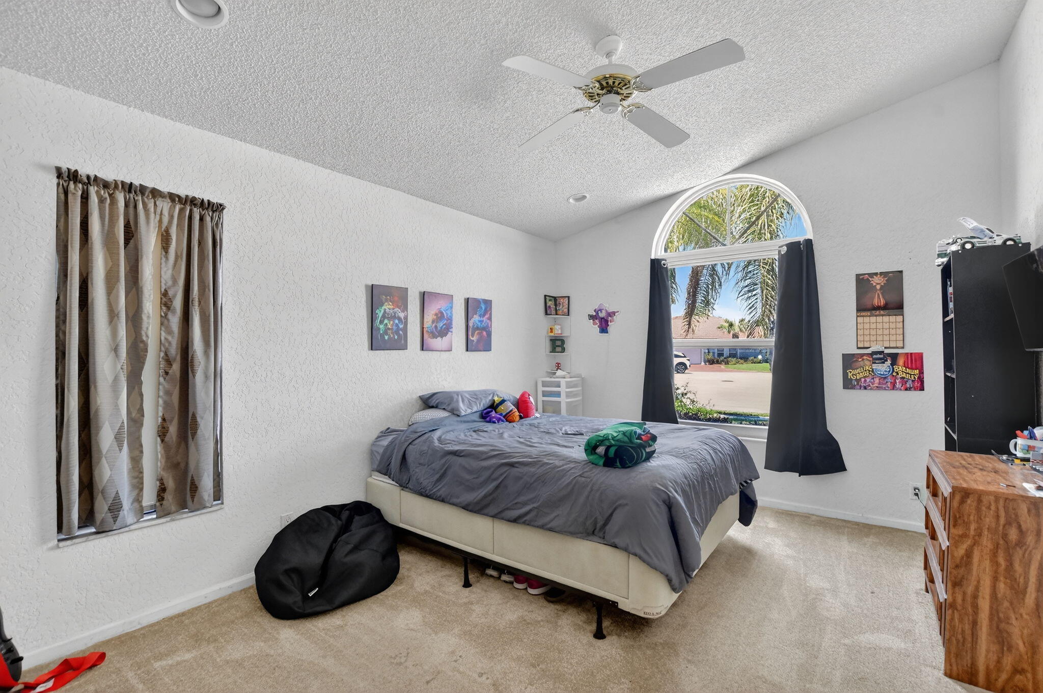 10226 Fresh Meadow Lane Boca Raton, FL 33498 - Photo 31 of 58 a bedroom with a bed and a chandelier