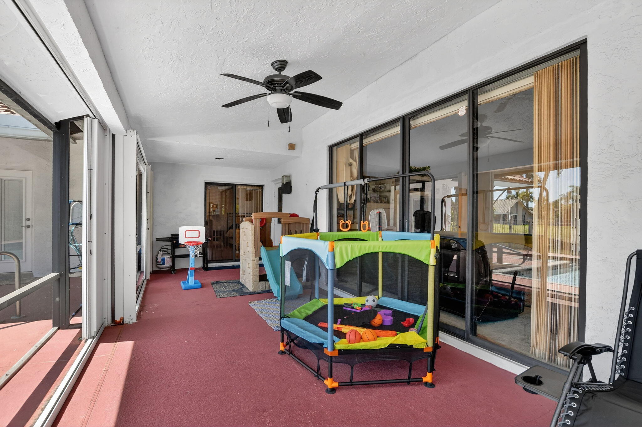 10226 Fresh Meadow Lane Boca Raton, FL 33498 - Photo 38 of 58 a living room with furniture a ceiling fan and a window
