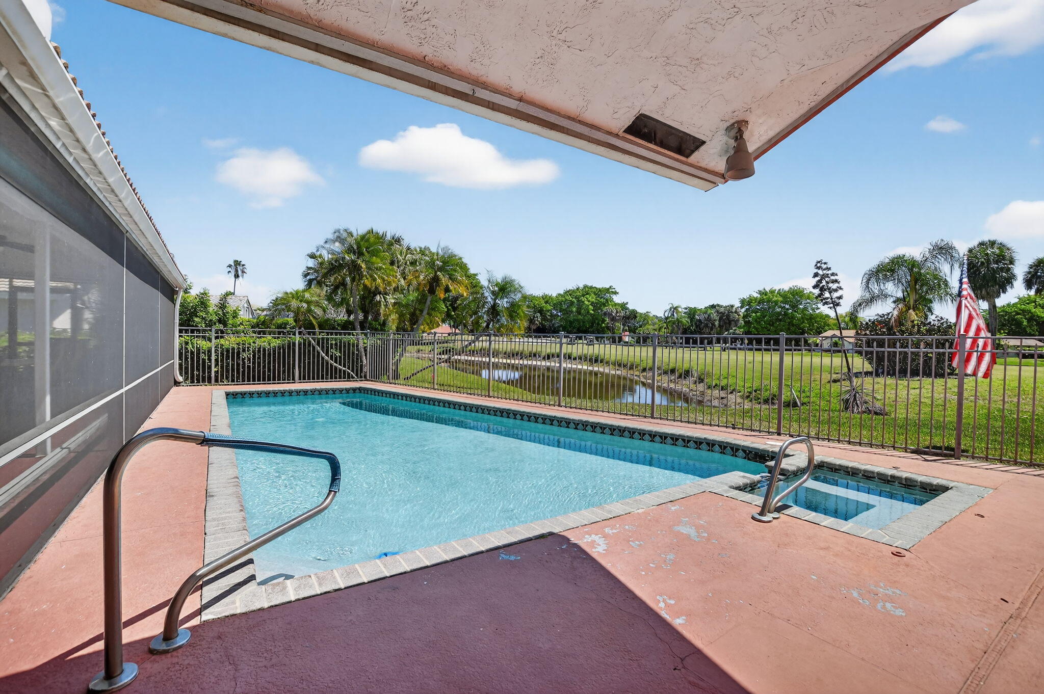 10226 Fresh Meadow Lane Boca Raton, FL 33498 - Photo 39 of 58 a view of a swimming pool with a patio and a yard