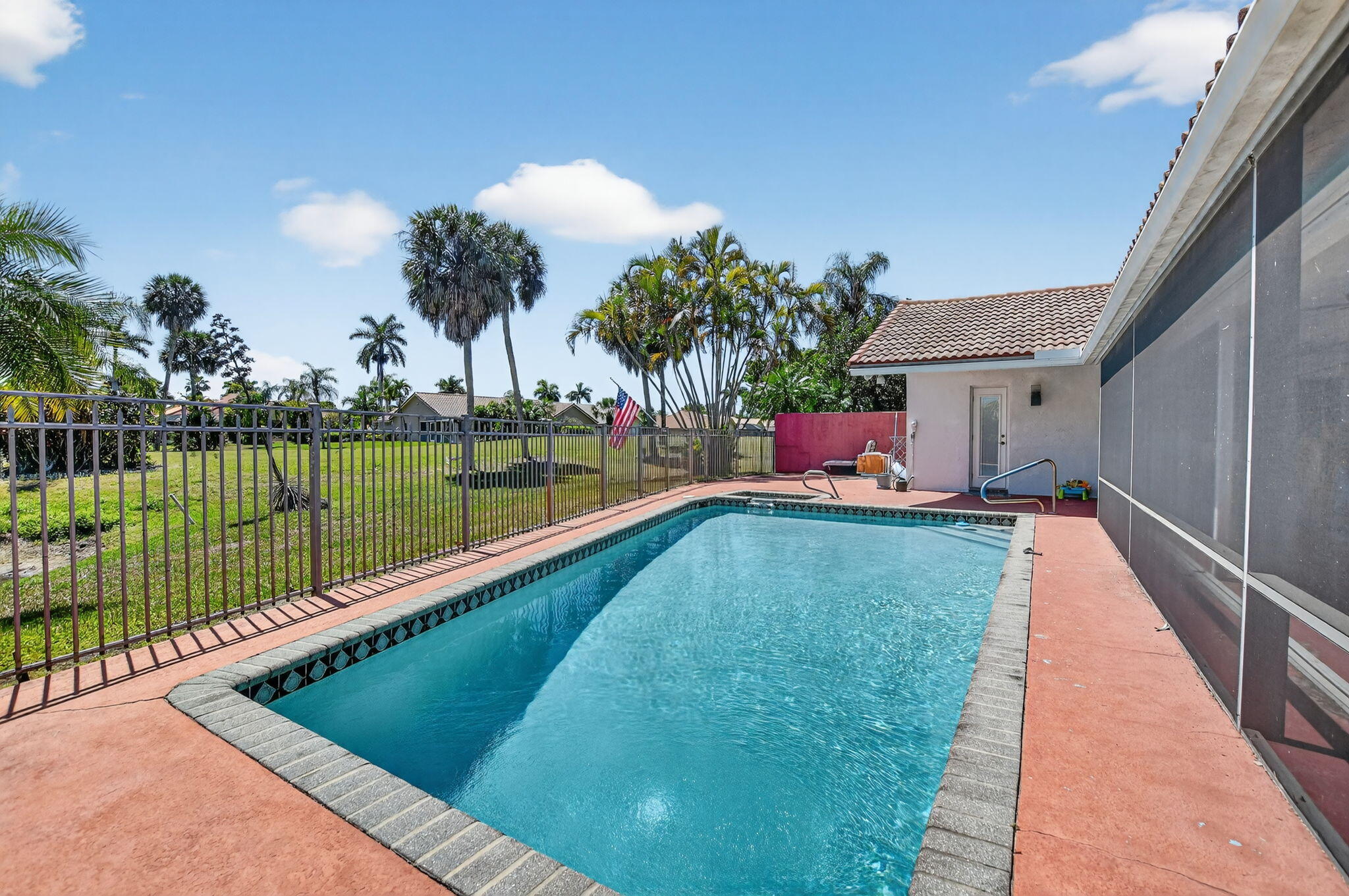 10226 Fresh Meadow Lane Boca Raton, FL 33498 - Photo 40 of 58 a view of a swimming pool with a patio and a lake view