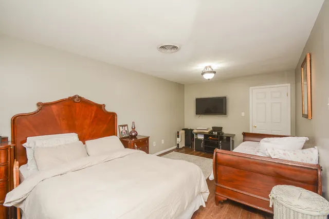 a bedroom with a bed and a couch